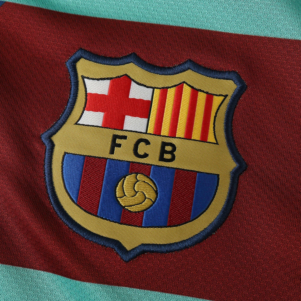 Elite Retro Kits Barcelona 2010/11 away shirt featuring a detailed embroidered FCB club crest on a maroon background.