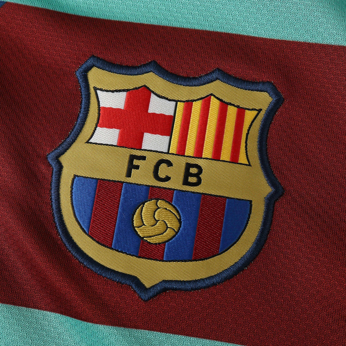 Elite Retro Kits Barcelona 2010/11 away shirt featuring a detailed embroidered FCB club crest on a maroon background.