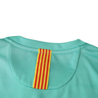 Elite Retro Kits Barcelona 2010/11 away shirt featuring a turquoise fabric and a yellow and red Senyera neck detail.
