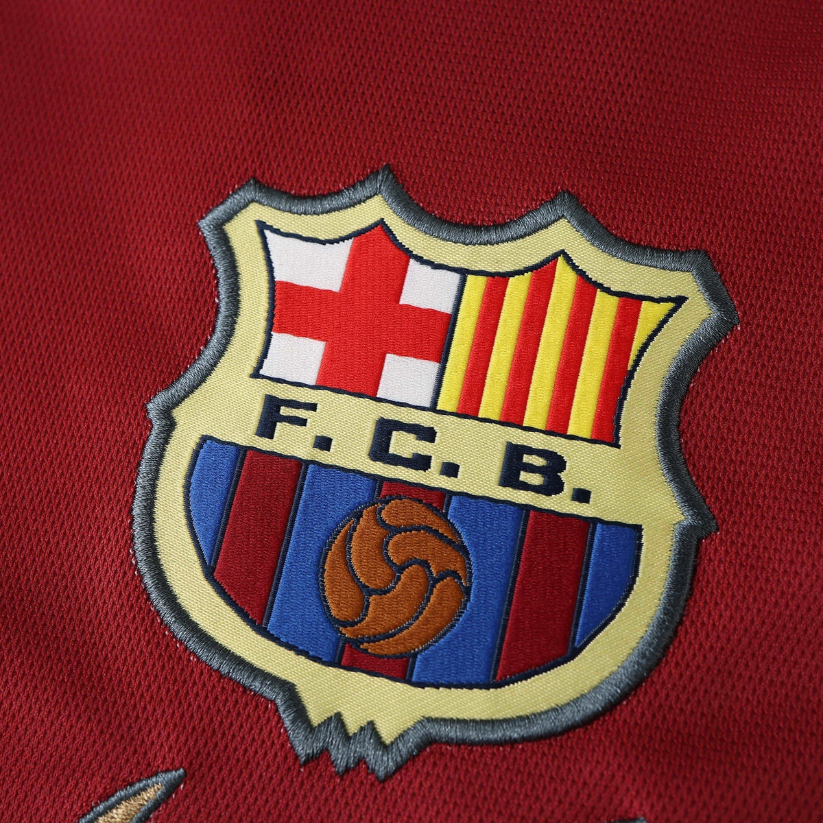 Elite Retro Kits Barcelona 1998-00 away shirt featuring a detailed embroidered FCB club crest on maroon fabric
