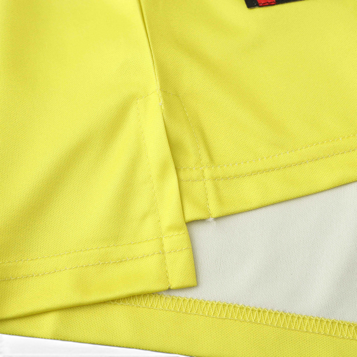 Elite Retro Kits Borussia Dortmund 1995/96 home shirt hem detail showing vibrant yellow fabric and stitched side vent