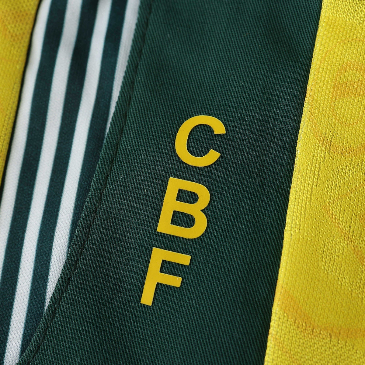 Elite Retro Kits Brazil 1992 home shirt detail showing the green collar with yellow CBF lettering and fabric pattern.