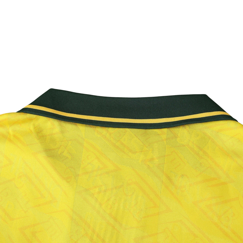 Elite Retro Kits Brazil 1992 home shirt featuring a yellow fabric with a subtle pattern and a dark green buttoned collar