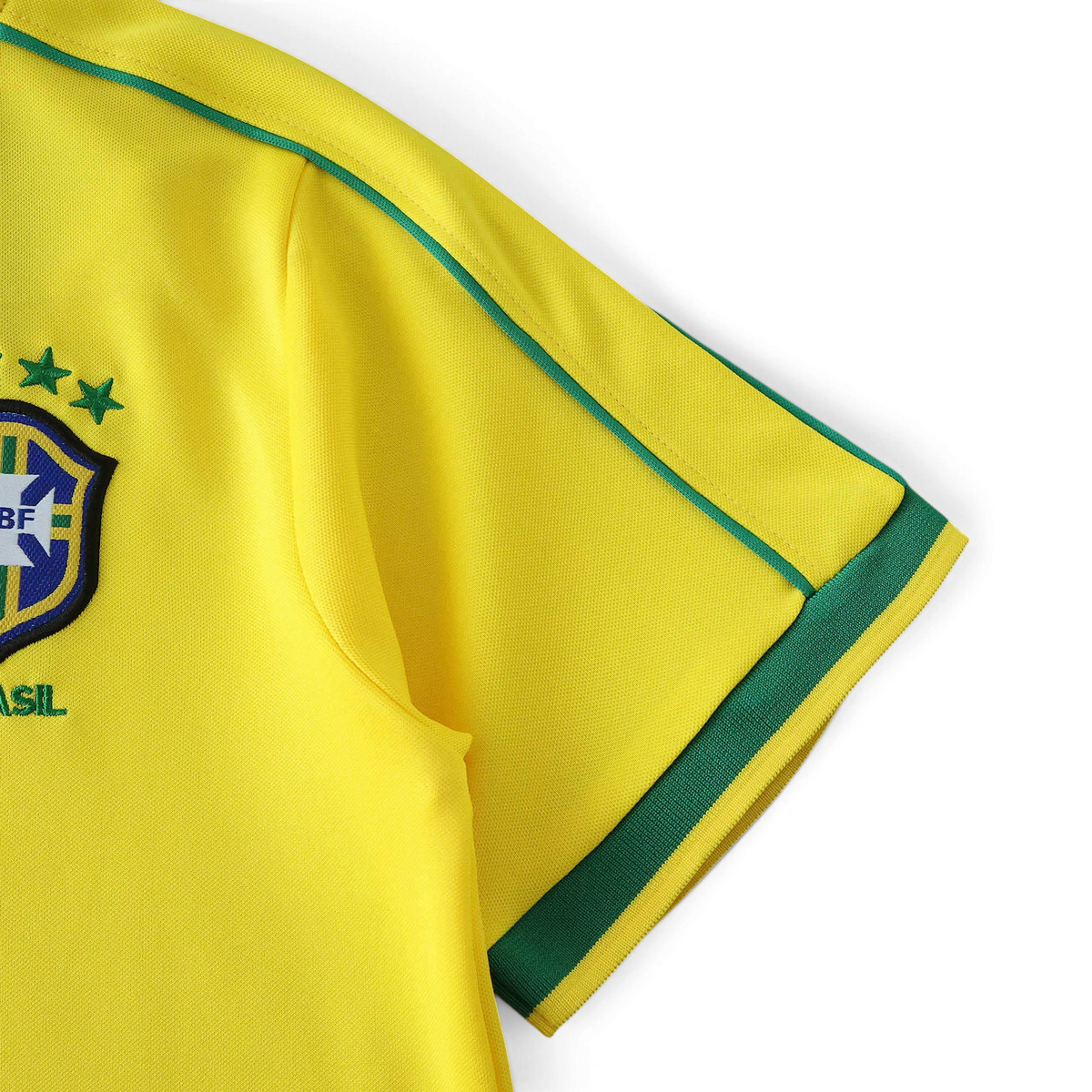 Elite Retro Kits Brazil 1998 kids home jersey sleeve detail featuring yellow fabric, green trim, and CBF crest