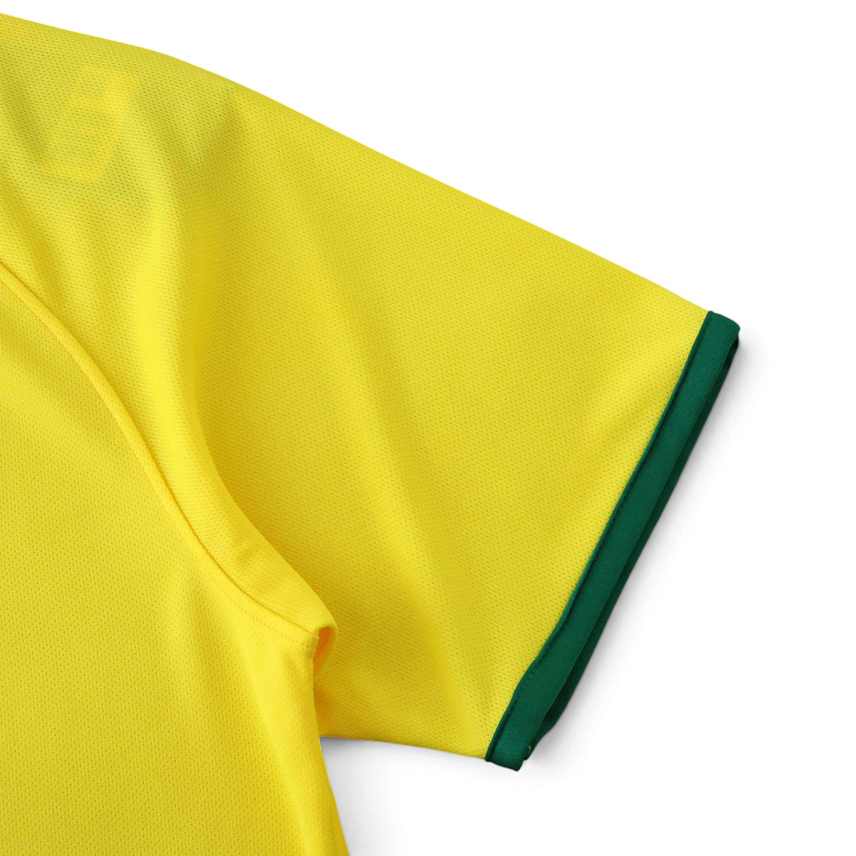 Elite Retro Kits Brazil 2014 home shirt sleeve detail in yellow with green trim on a green pitch background