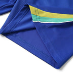 Elite Retro Kits Brazil 2026 kids home football kit featuring a blue jersey with yellow and green sleeve trim detail.