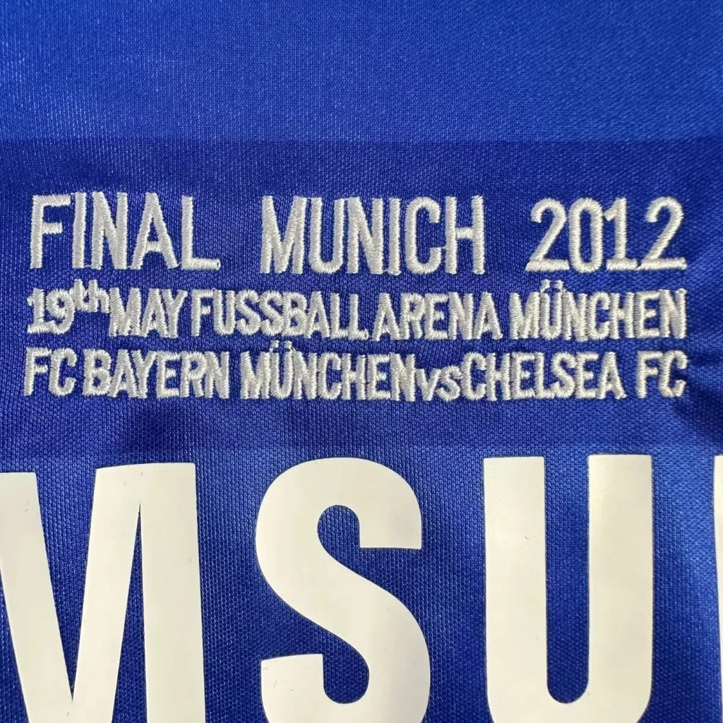 Elite Retro Kits Chelsea 2011/12 UCL Final home shirt detail featuring embroidered Munich 2012 match text in blue