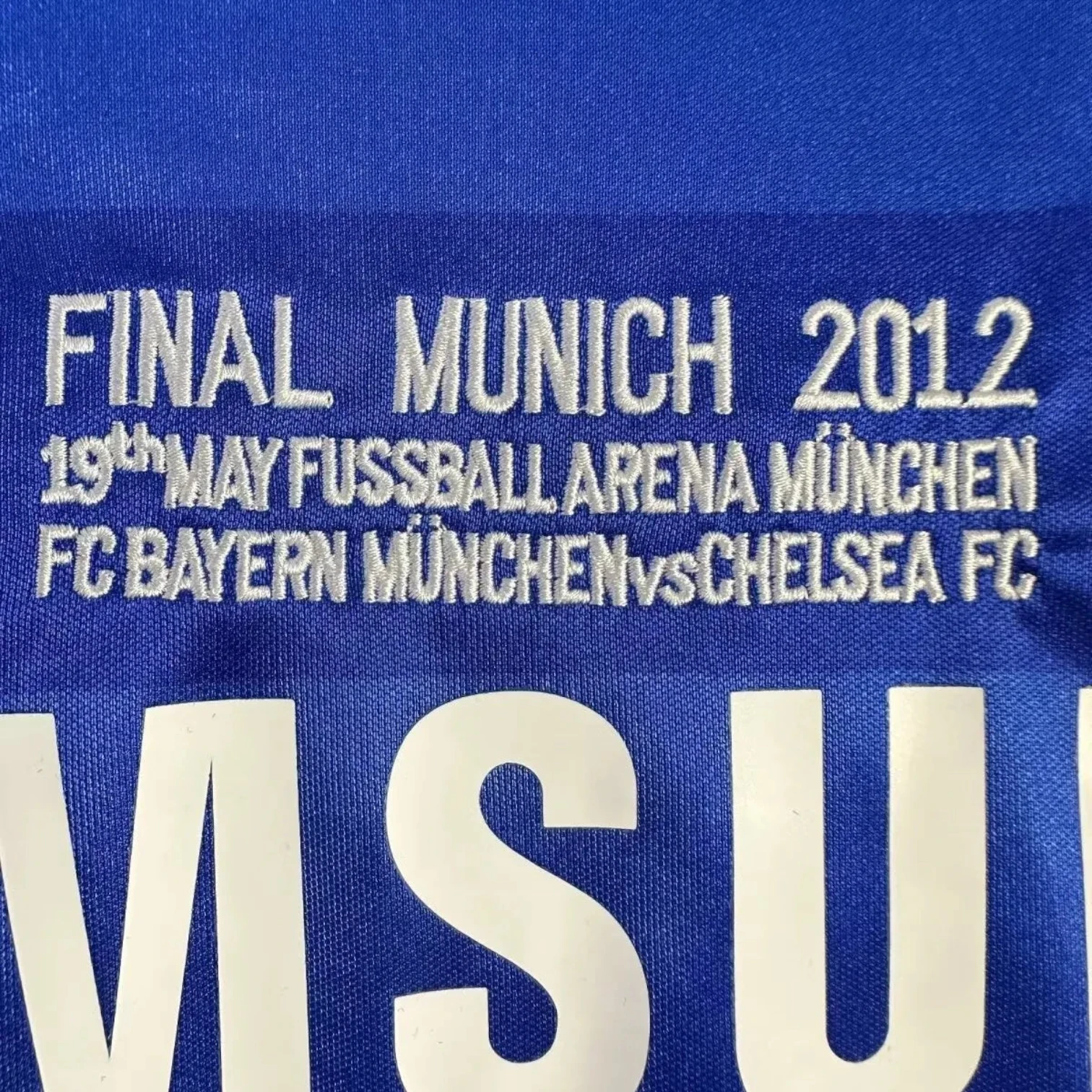 Elite Retro Kits Chelsea 2011/12 UCL Final home shirt detail featuring embroidered Munich 2012 match text in blue