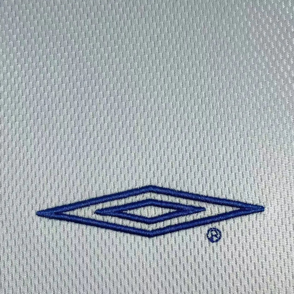 Elite Retro Kits Chelsea 2003/05 away shirt featuring a blue embroidered Umbro logo on a grey mesh fabric texture.