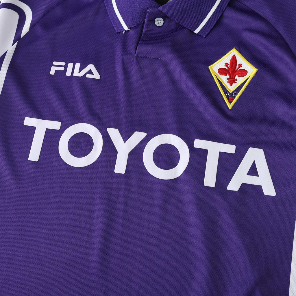 Elite Retro Kits Fiorentina 1999/00 home shirt in purple with white collar, Fila logo, and Toyota sponsor detail.