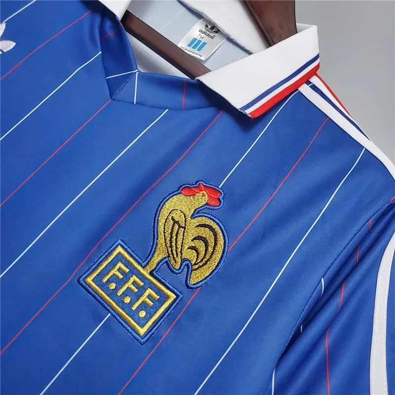 Elite Retro Kits France 1982 home football shirt in blue with white pinstripes, tricolour collar, and FFF rooster crest
