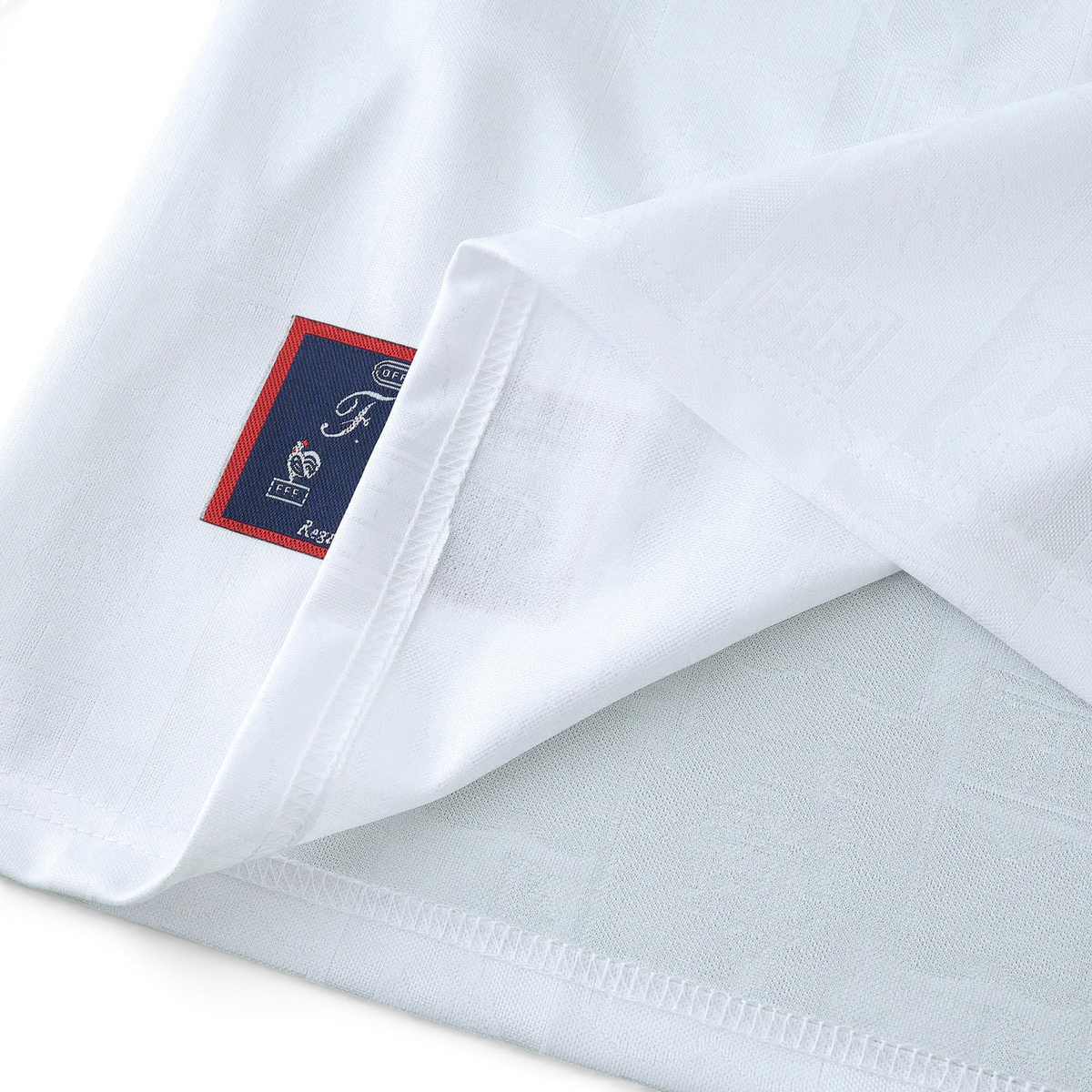 Elite Retro Kits France 1996 away shirt in white with a detailed embroidered cockerel emblem on the hem tag