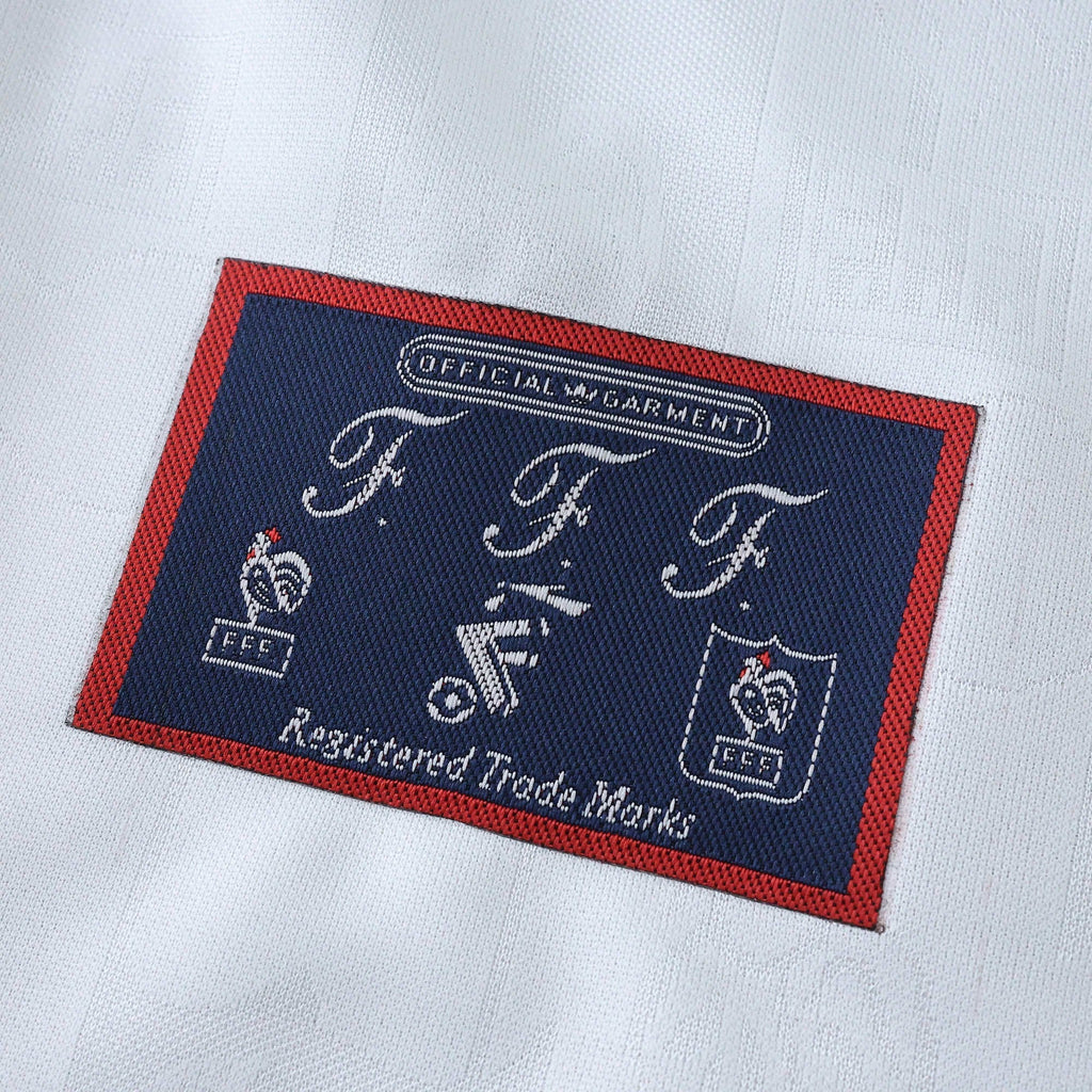 Elite Retro Kits France 1996 away shirt detail showing the official FFF woven brand patch on white fabric