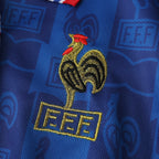Elite Retro Kits France 1996 home shirt featuring an embroidered golden cockerel crest on a blue patterned fabric