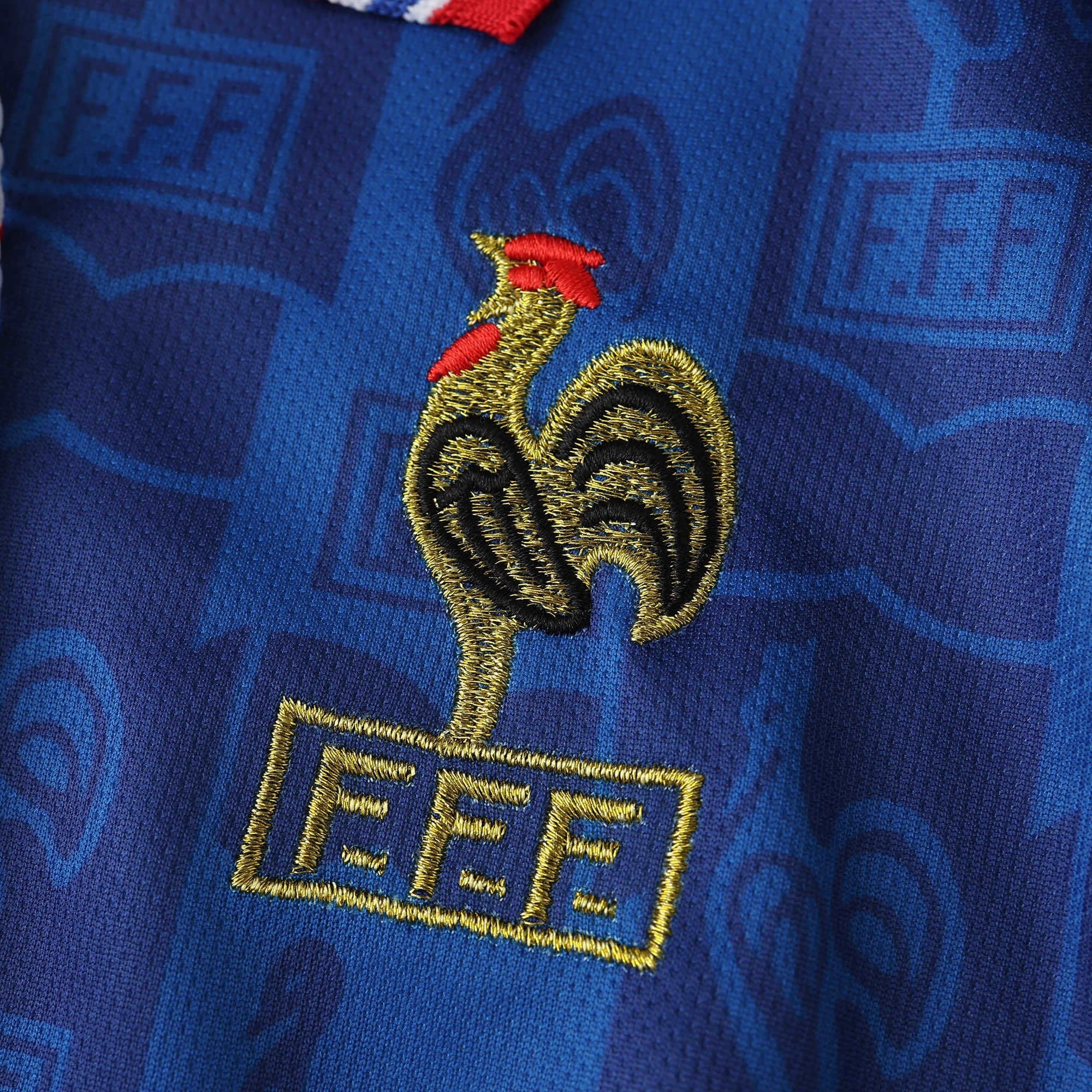 Elite Retro Kits France 1996 home shirt featuring an embroidered golden cockerel crest on a blue patterned fabric