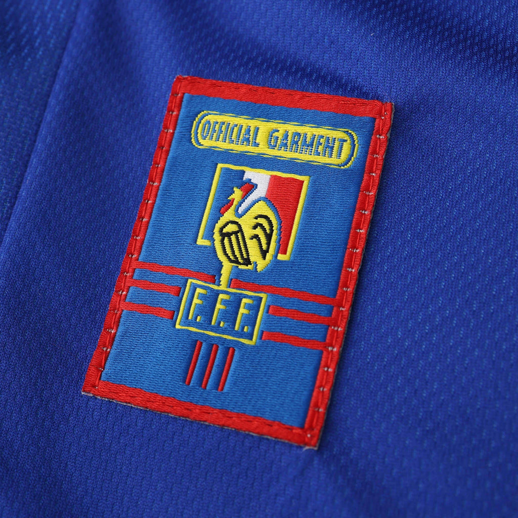 Elite Retro Kits France 1998 World Cup home shirt featuring the embroidered FFF cockerel crest on deep blue fabric.
