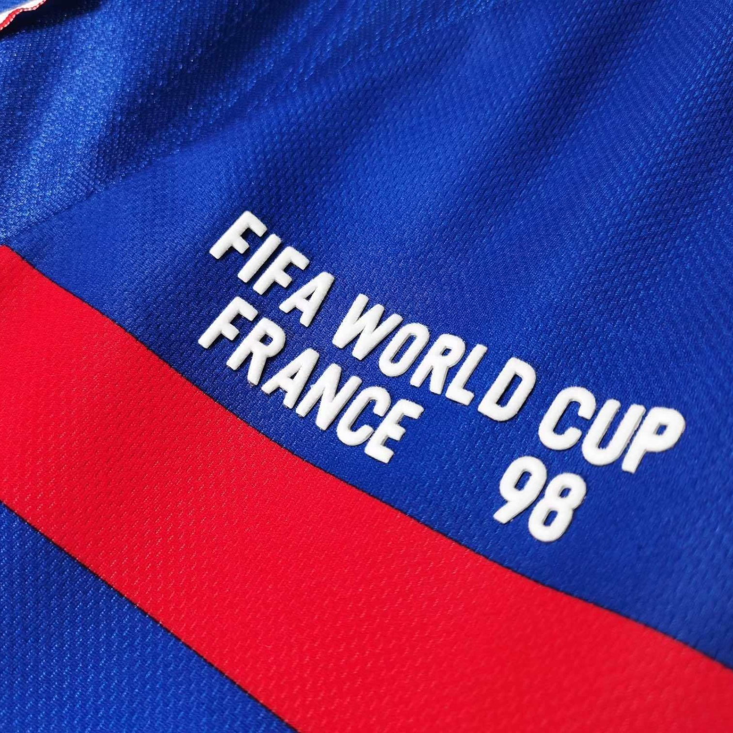 Elite Retro Kits France 1998 World Cup home shirt detail featuring white text on deep blue and red fabric