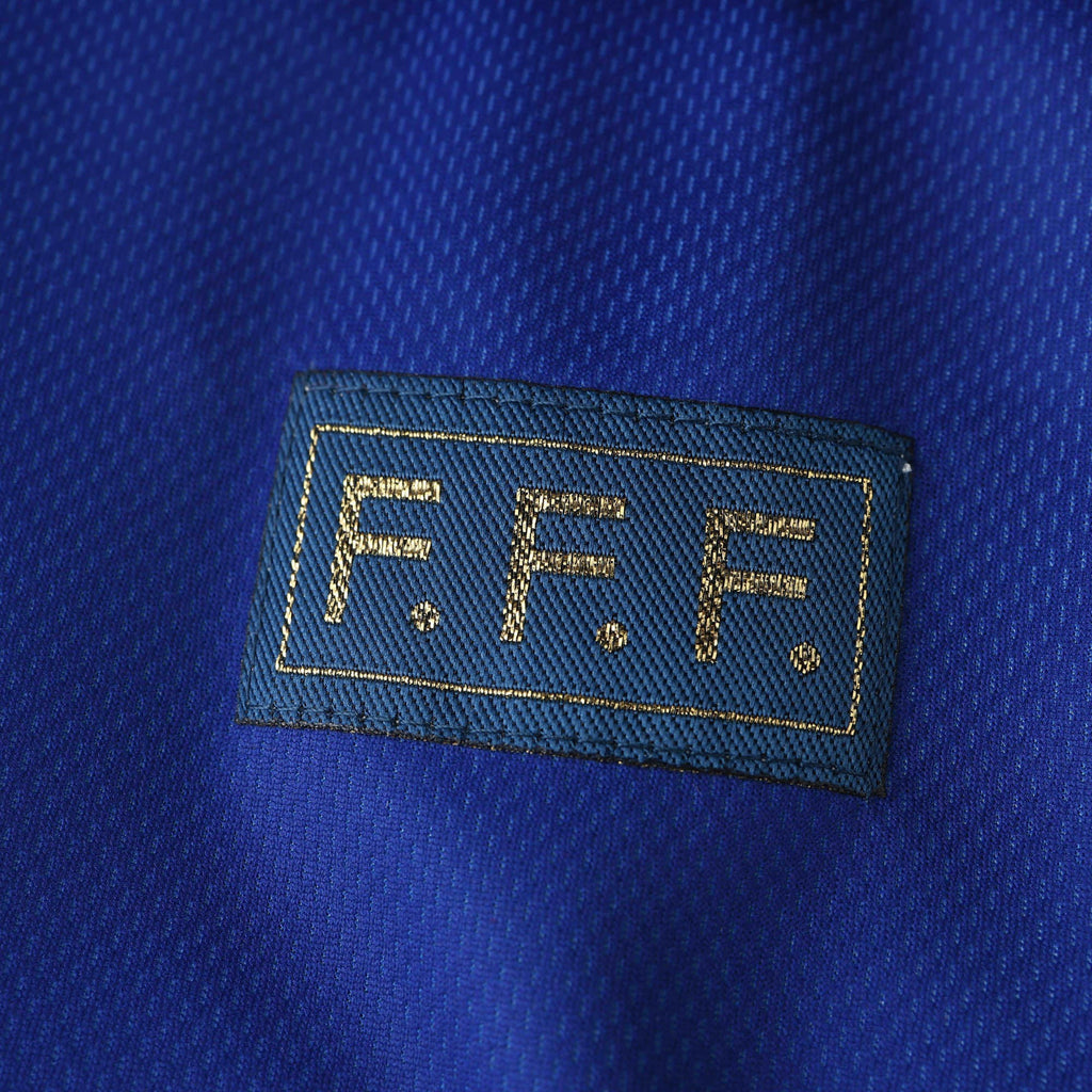 Elite Retro Kits France 1998 World Cup home shirt detail featuring the gold F.F.F. emblem on deep blue fabric