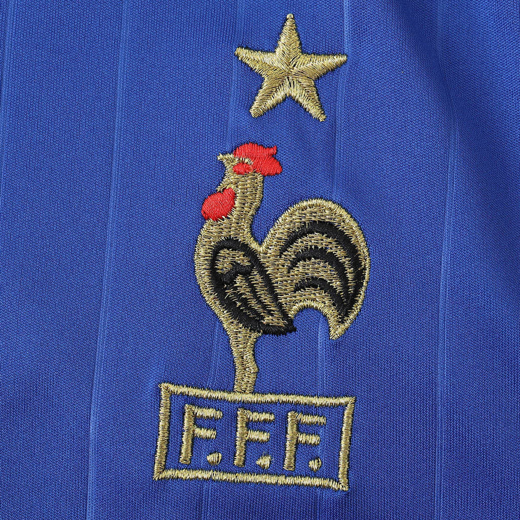 Elite Retro Kits France 2006 home shirt featuring an embroidered cockerel crest and gold star on deep blue fabric.