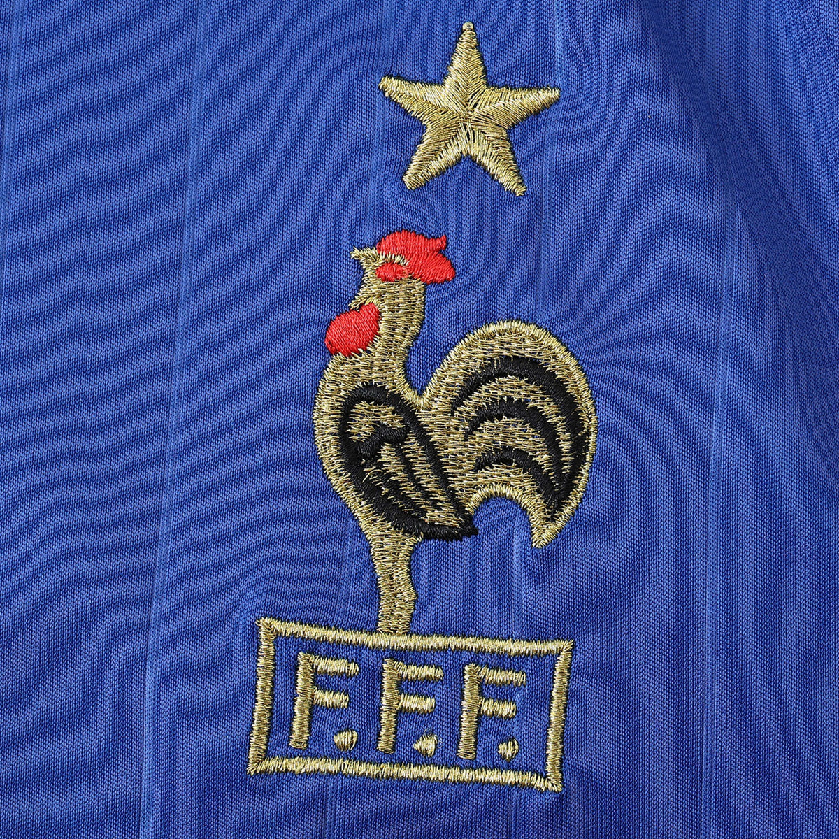 Elite Retro Kits France 2006 home shirt featuring an embroidered cockerel crest and gold star on deep blue fabric.