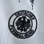 Elite Retro Kits Germany 1994 home kids kit featuring a detailed black embroidered DFB crest on a white jersey