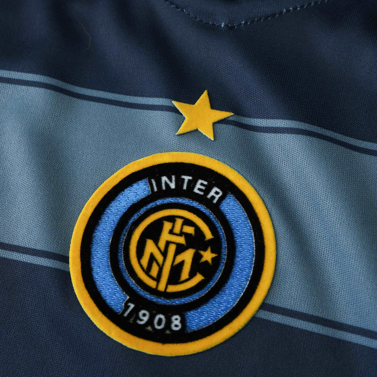 Elite Retro Kits Inter Milan 2004/05 third shirt detail featuring the club crest and yellow star on blue striped fabric