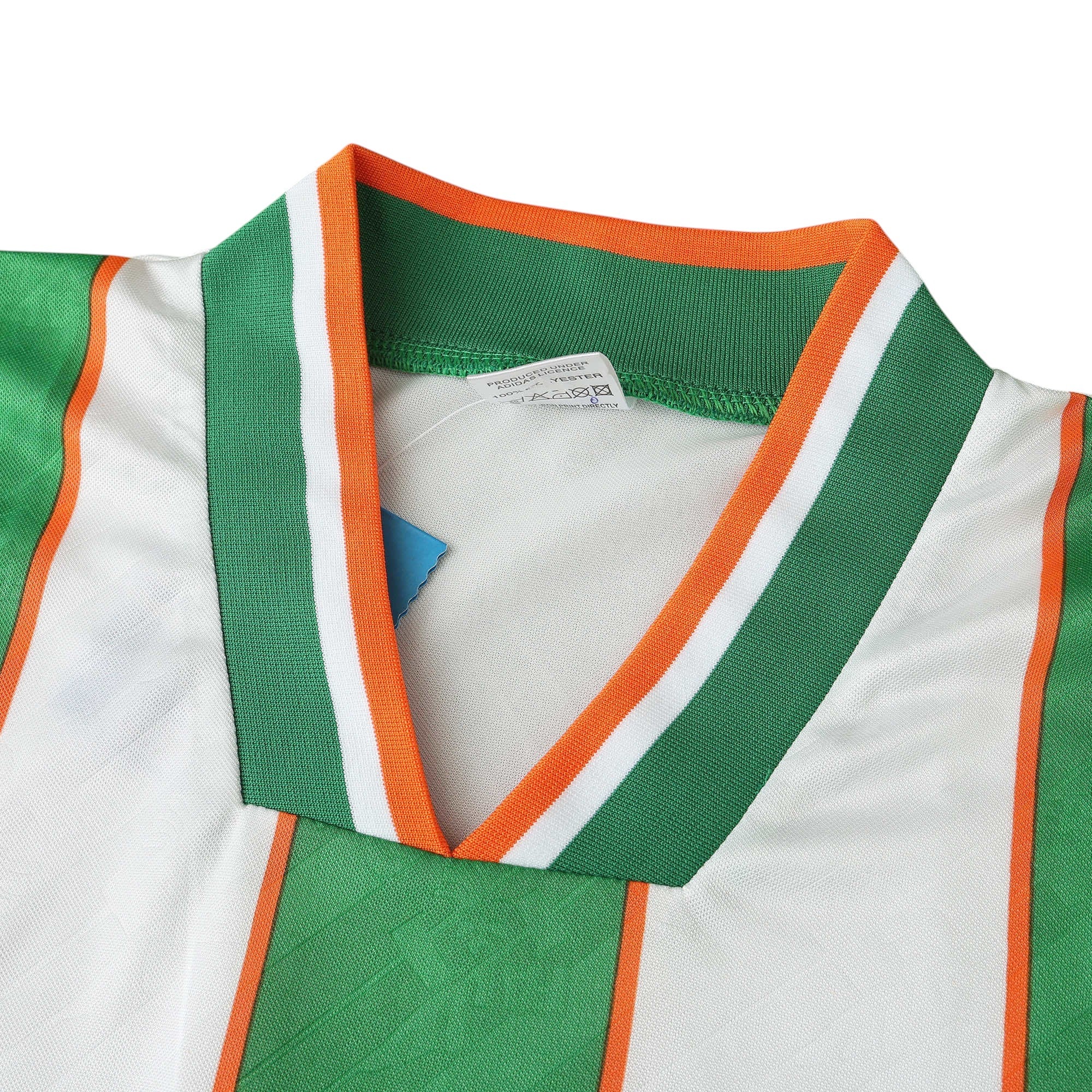 Elite Retro Kits Ireland 1994 away football shirt featuring a white V-neck collar with green and orange trim details.