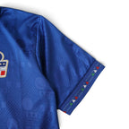 Elite Retro Kits Italy 1994 home football shirt in blue with subtle geometric pattern and tricolour sleeve trim.