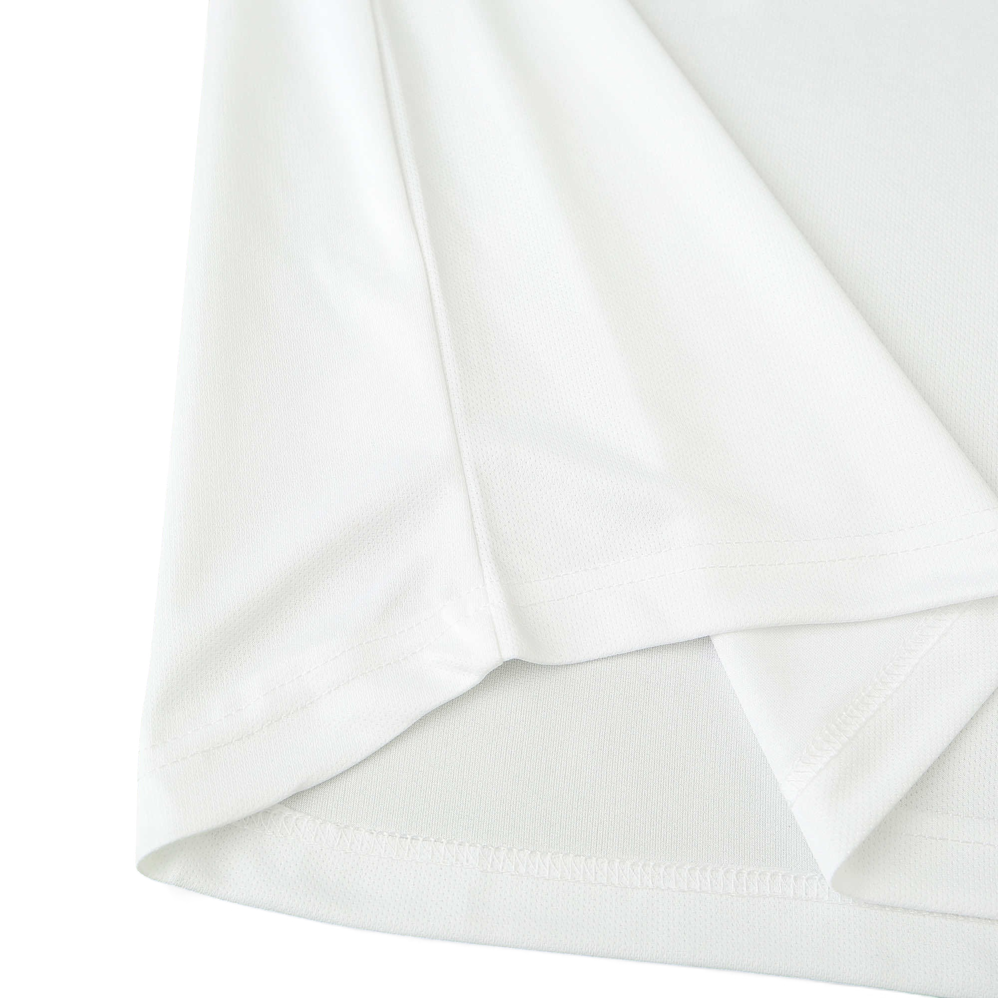 Close-up of the white fabric texture and hem detail on an Elite Retro Kits Italy 1996 away football shirt.