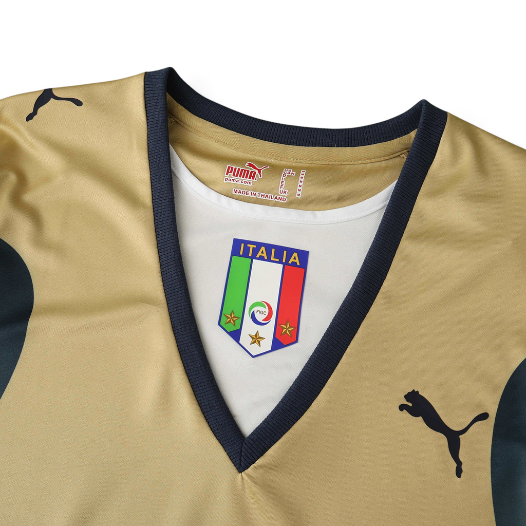 Elite Retro Kits Italy 2006 goalkeeper shirt in gold with navy trim, featuring the iconic FIGC crest and Puma logo.