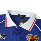 Elite Retro Kits Japan 1998 home football shirt featuring a white collar, blue fabric, and JFA crest detail.