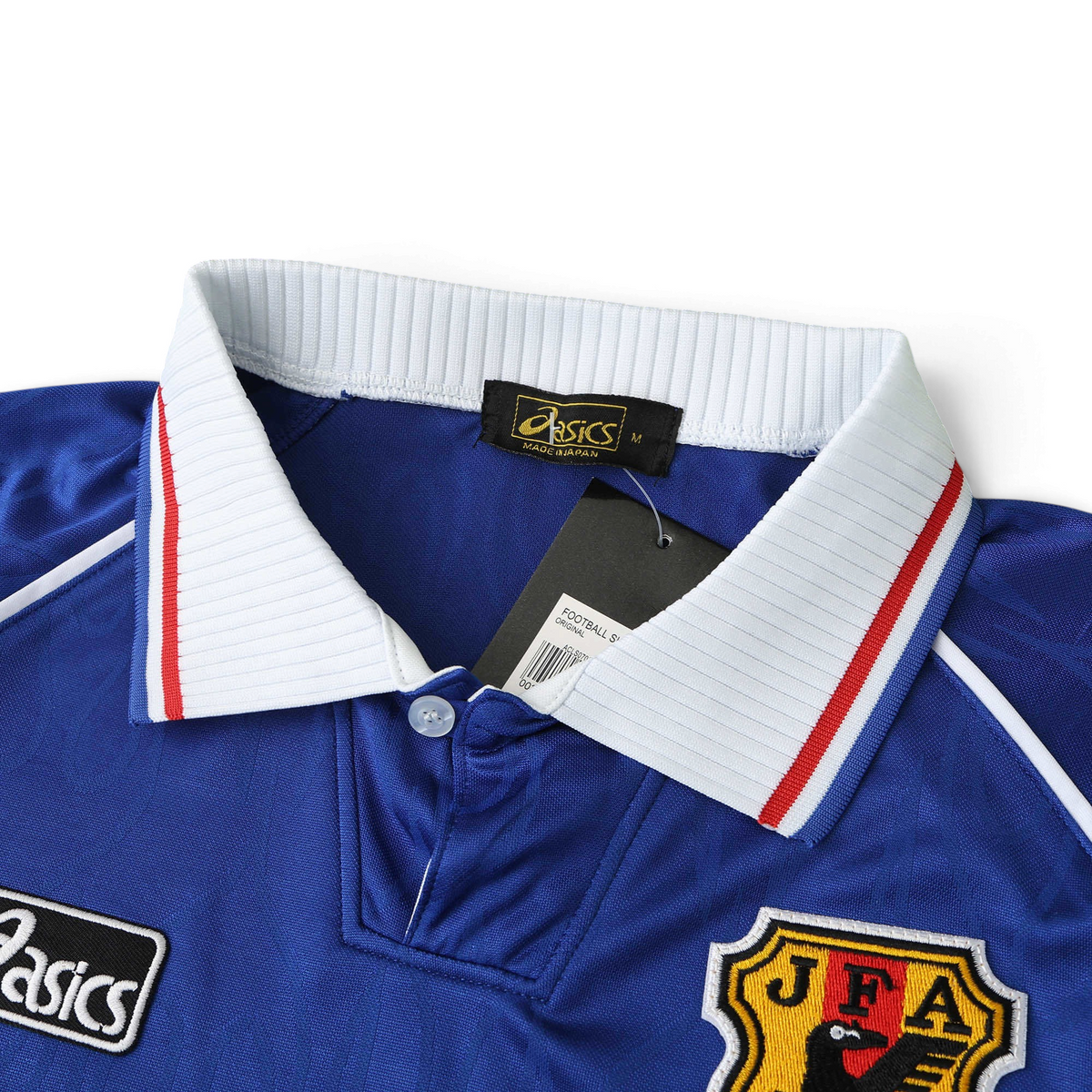 Elite Retro Kits Japan 1998 home football shirt featuring a white collar, blue fabric, and JFA crest detail.