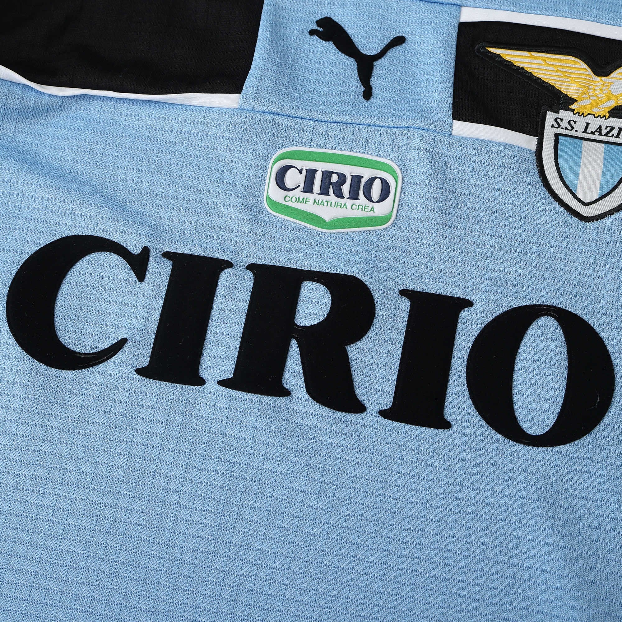 Elite Retro Kits Lazio 1998/99 home shirt in sky blue with black accents, Cirio sponsor logo, and club crest.