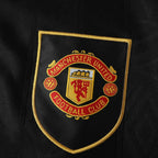 Elite Retro Kits Manchester United 1993-1995 away shirt featuring the embroidered club crest on a black fabric base