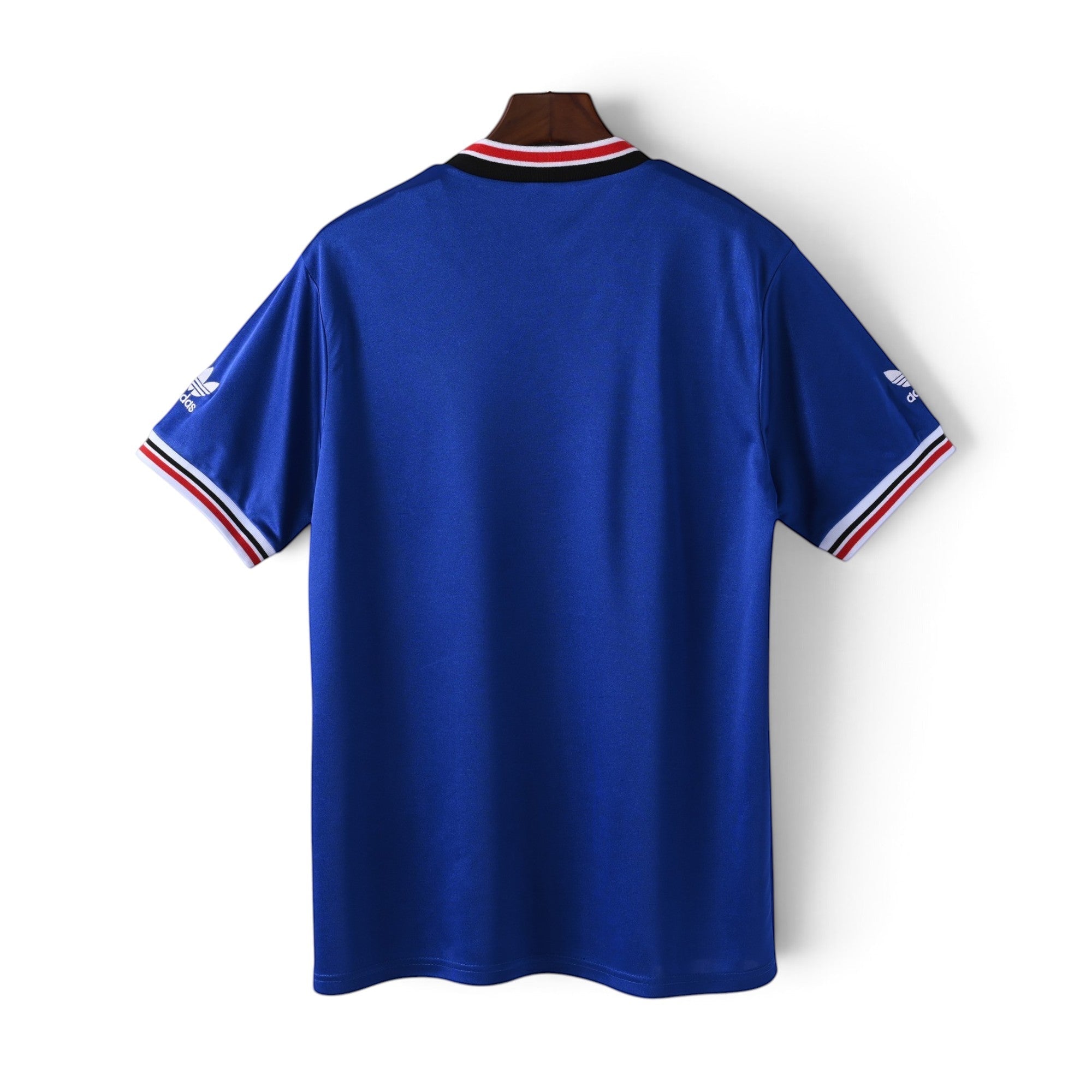 Elite Retro Kits Manchester United 1985/1986 away jersey in blue with red, white, and black striped collar and cuffs.