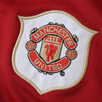 Elite Retro Kits Manchester United 2006/07 kids home kit featuring the embroidered club crest on red fabric