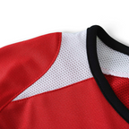 Elite Retro Kits kids Manchester United 2005/06 home jersey featuring red and white mesh panels and black collar trim.