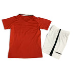 Elite Retro Kits Manchester United 1999/00 kids home kit featuring a red jersey and white shorts with Umbro branding.