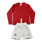 Elite Retro Kits Manchester United 2007/08 kids home kit featuring a red long-sleeve jersey and white football shorts.