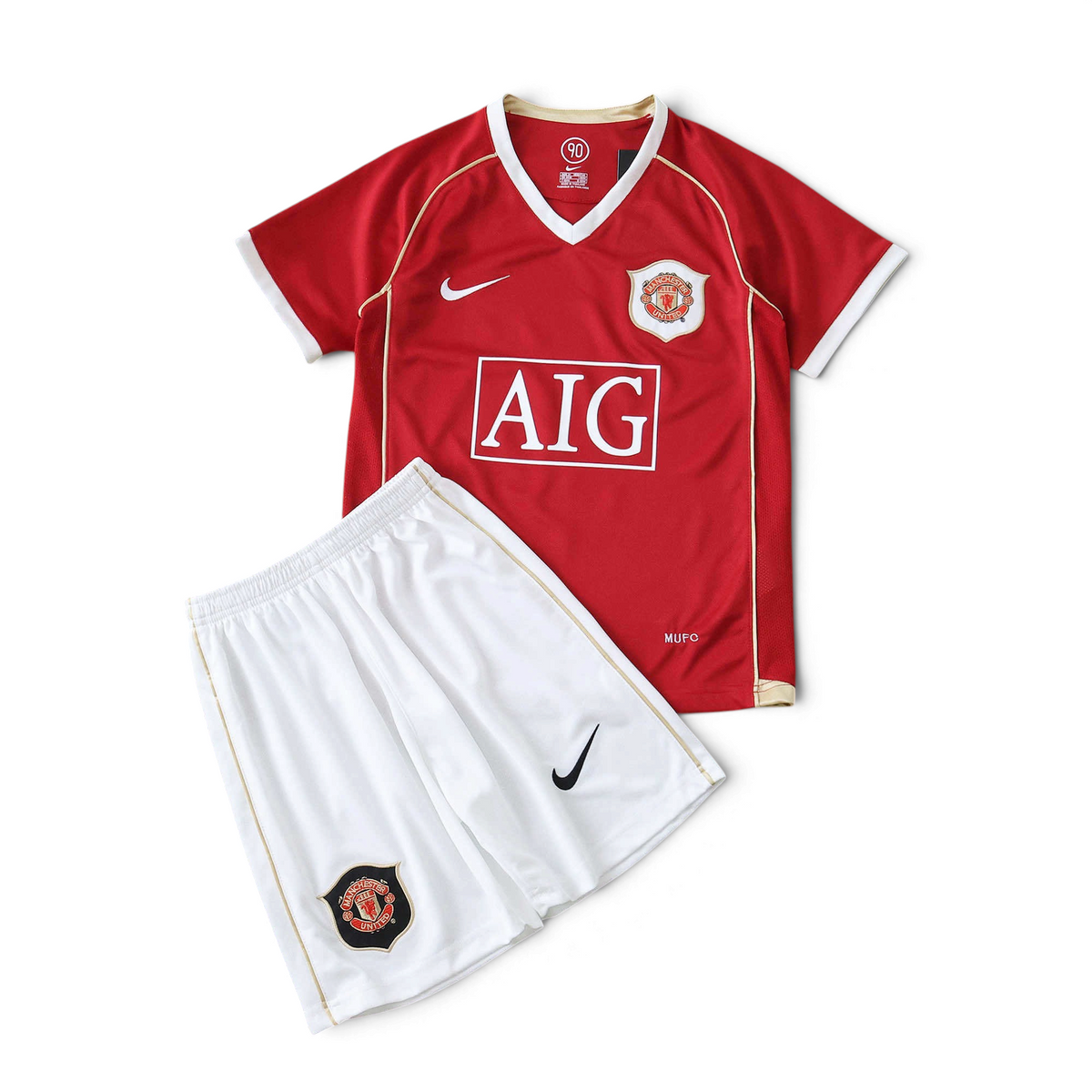 Elite Retro Kits Manchester United 2006/07 kids home kit featuring a red jersey and white shorts with club crests.