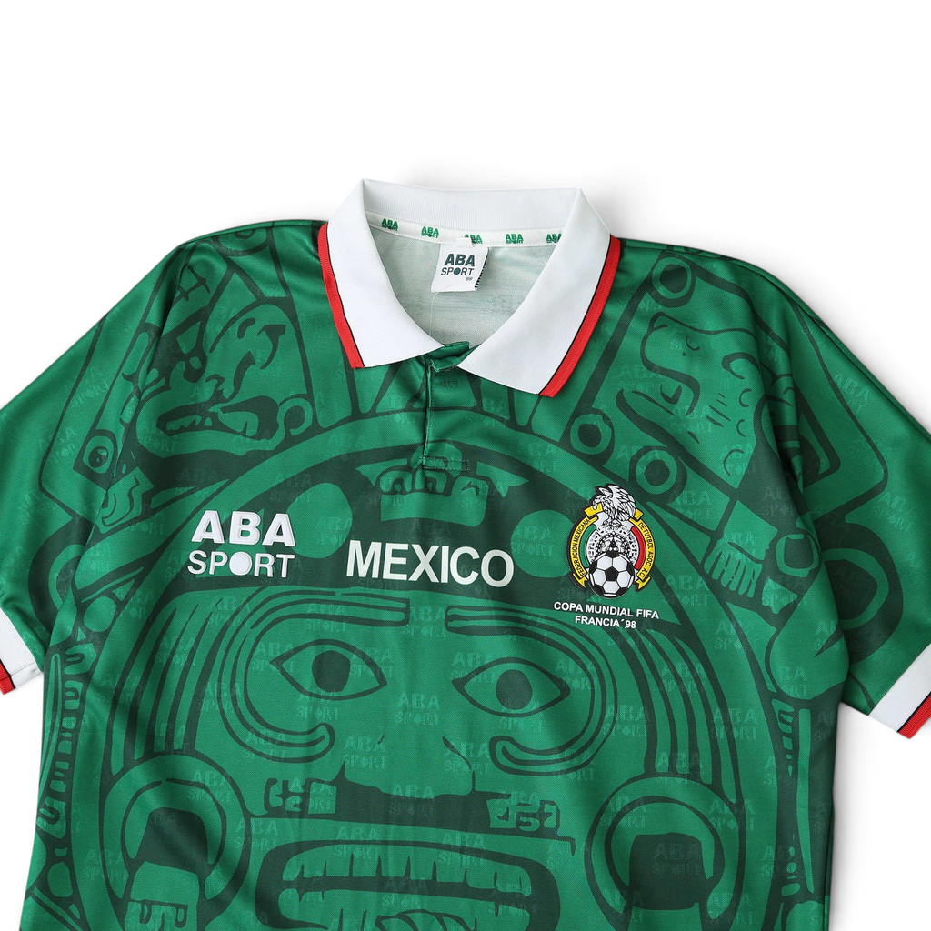 Elite Retro Kits Mexico 1998 home football shirt in green with Aztec pattern, white collar, and FMF crest detail.