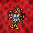Elite Retro Kits Portugal 2004 home shirt featuring a detailed embroidered FPF crest on a red patterned fabric