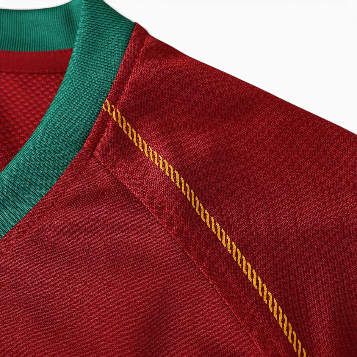 Elite Retro Kits Portugal 2006 home shirt detail showing red fabric, green ribbed collar, and gold shoulder stitching.