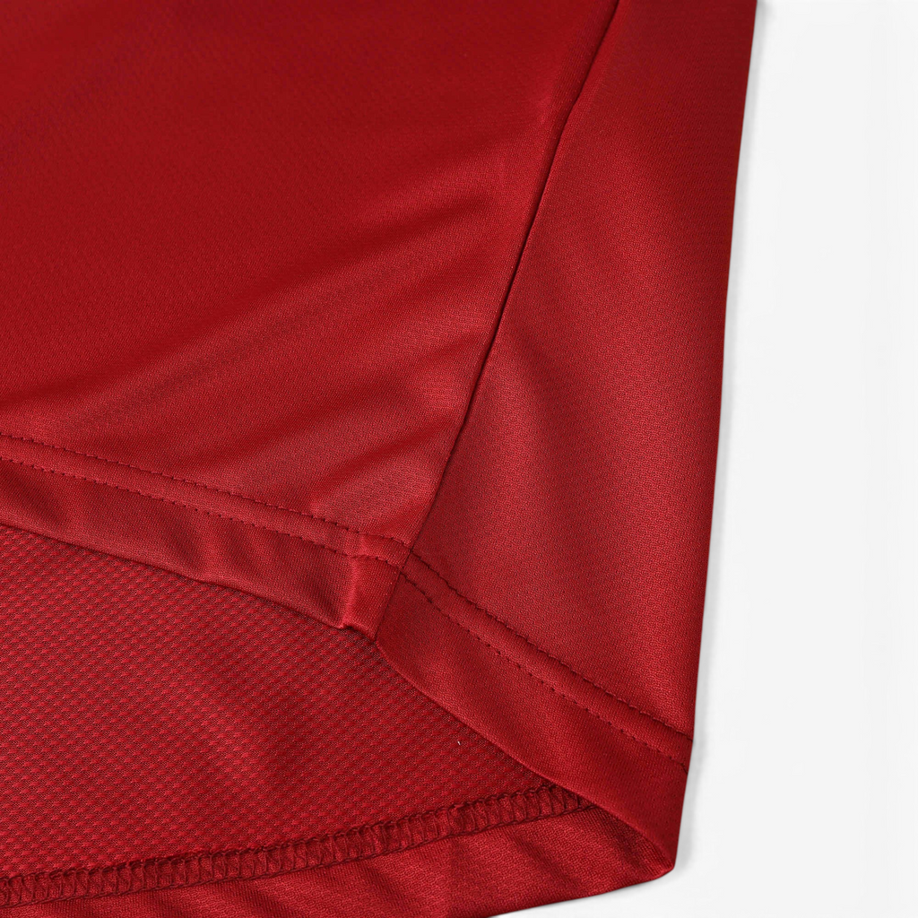 Close-up of the red fabric and hem detail on an Elite Retro Kits Portugal 2006 home football shirt.