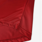 Close-up of the red fabric and hem detail on an Elite Retro Kits Portugal 2006 home football shirt.