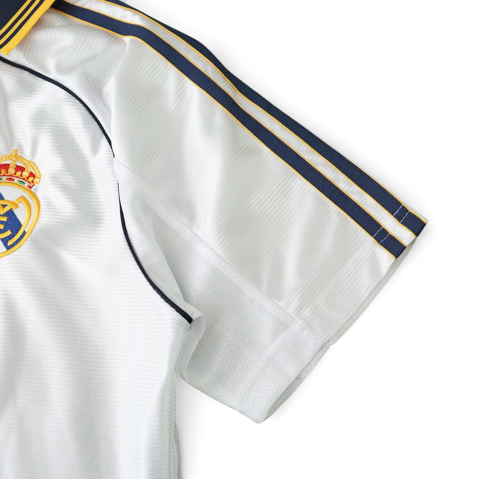 Elite Retro Kits Real Madrid 1999/00 home shirt featuring white fabric, blue and yellow shoulder stripes, and crest.