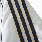 Elite Retro Kits Real Madrid 1999/00 home shirt featuring white fabric with navy and yellow adidas shoulder stripes.