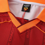Elite Retro Kits Roma 1999/00 home shirt featuring deep red fabric, orange collar, and Diadora branding details.