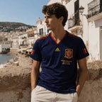 Elite Retro Kits Spain 2010 World Cup final navy blue away shirt with gold detailing worn by a model outdoors