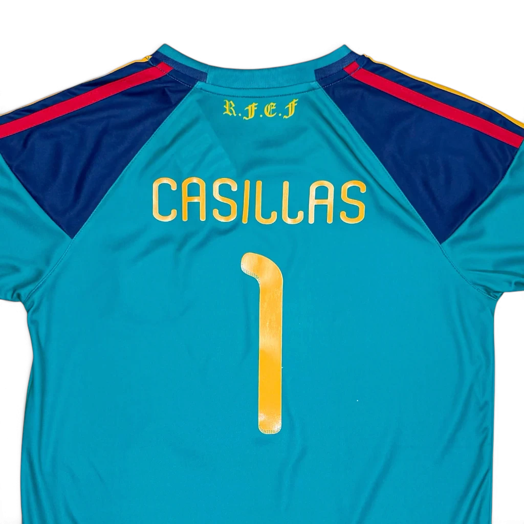 Elite Retro Kits Spain 2010 kids goalkeeper shirt in teal with Casillas 1 print and yellow and red shoulder details